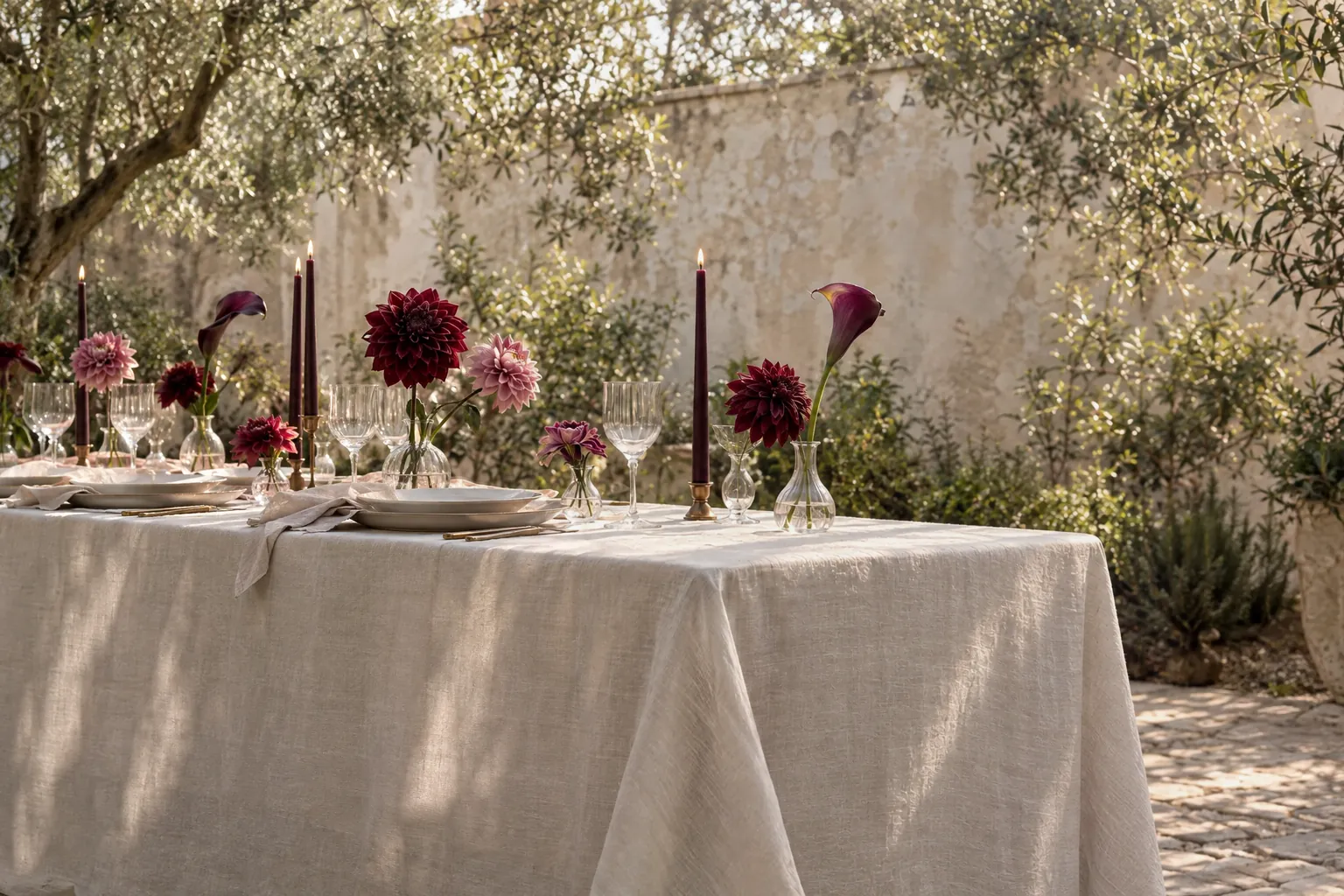 The same table before, with only a plain linen tablecloth and a bare wall behind it